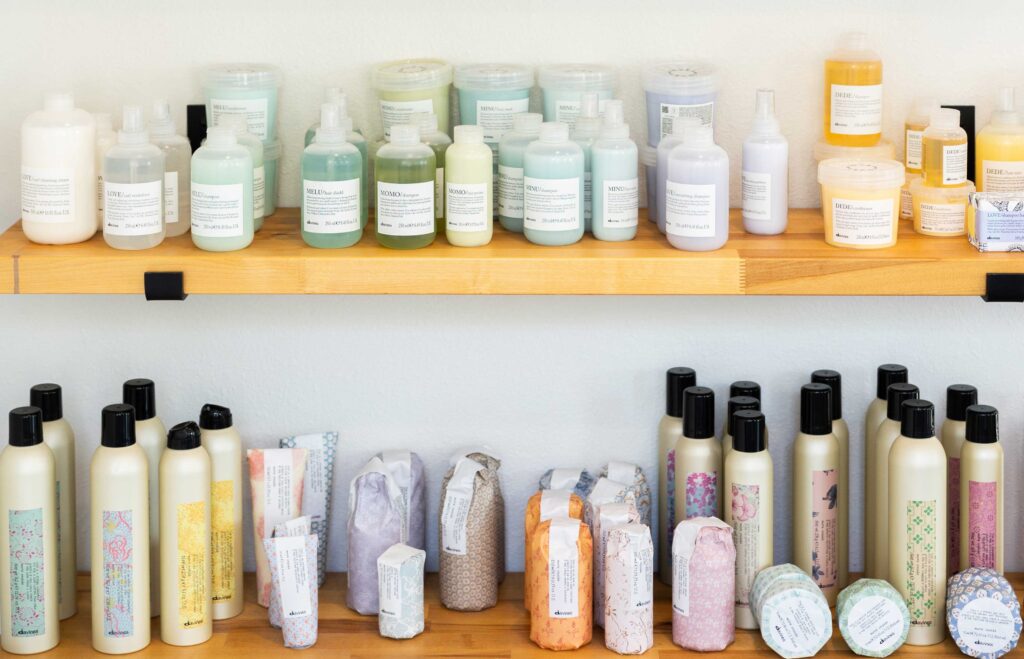 Shelves displaying various hair products from REF and Davines